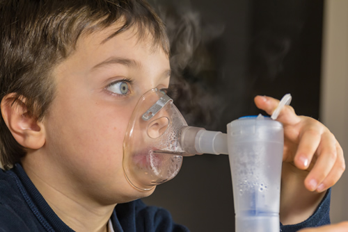 photo of boy using a nebulizer respiratory equipment